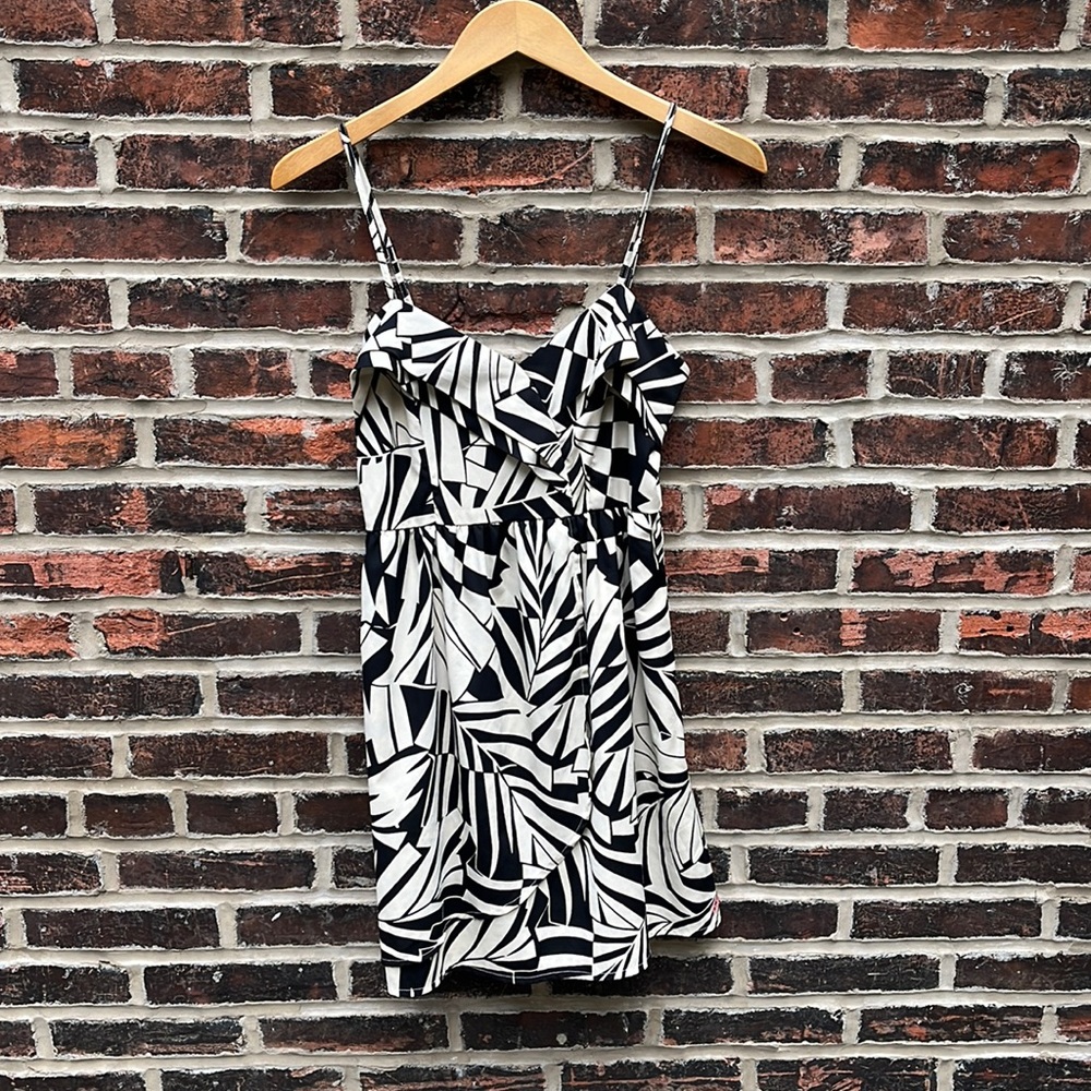 Spaghetti strap dress, mini length. Size small. Tear near zipper on back.